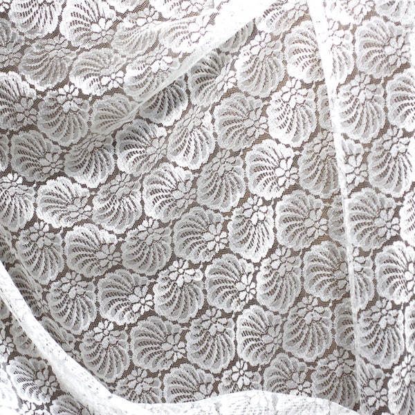 Lace fabric by the yard.  White lace with a sea shell design.
