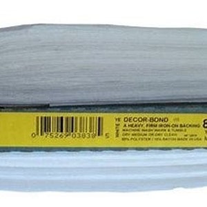 May include: A white roll of Pellon Decor Bond 809, a heavy firm iron-on backing for fabric. The label reads "Pellon Decor Bond 809, a heavy firm iron-on backing.  Yard: 22.5"