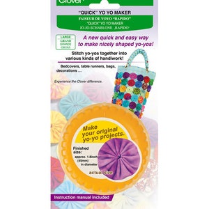 May include: A Clover "Quick" Yo Yo Maker kit. The package features a yellow plastic yo-yo maker with a finished size of approximately 1.8 inches (45mm) in diameter. The kit includes an instruction manual and is designed for making yo-yos for various craft projects.