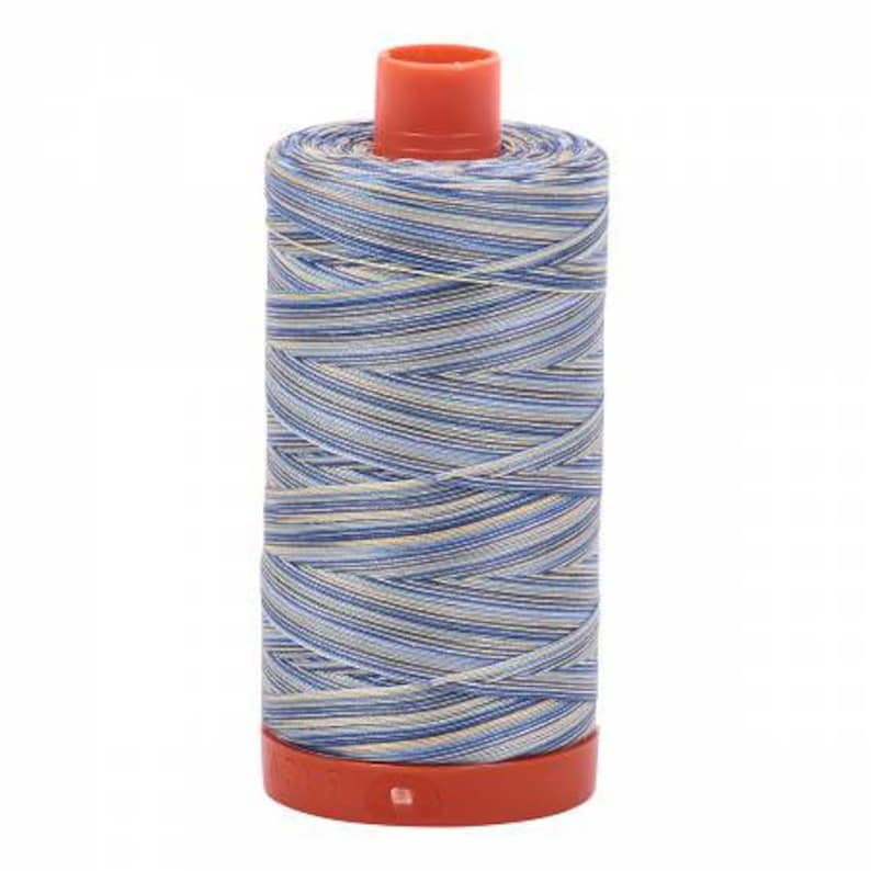 May include: A spool of blue and white striped thread with a red plastic bobbin.
