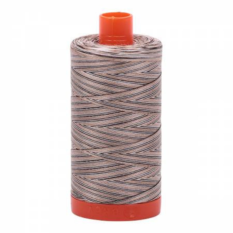 May include: A spool of brown and white striped thread with an orange plastic top and bottom.