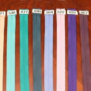 Puede incluir: Una selecci&oacute;n de diez cintas de cremallera en varios colores, incluyendo amarillo, rosa, turquesa, verde, azul, morado y marr&oacute;n. Cada cinta est&aacute; etiquetada con un n&uacute;mero.