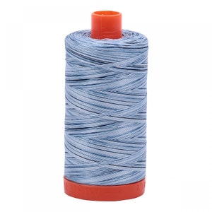 May include: A spool of light blue thread with a red and orange plastic bobbin.