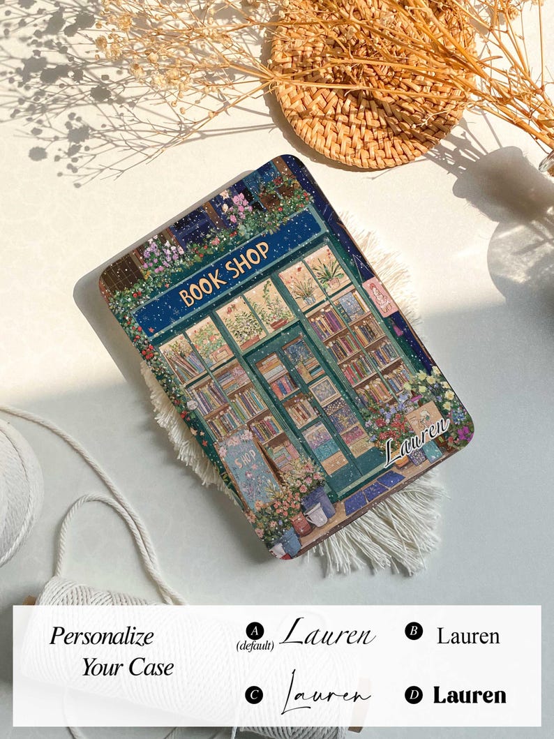 May include: A personalized phone case with a colorful illustration of a book shop with the text "BOOK SHOP" above the door. The case has a snowy background and the name "Lauren" is written in cursive on the bottom right corner.