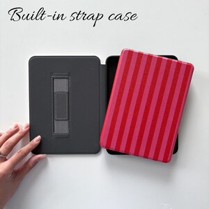 May include: A grey tablet case with a built-in strap, open to show a tablet with a red and pink striped cover. The text "Built-in strap case" is above the case. The Moonlight ArtsFL studio logo is in the bottom right corner.