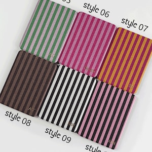 May include: A selection of rectangular cases featuring vertical stripes in diverse colour schemes. Styles include green and pink, pink and red, gold and orange, brown, black and white, and pink and black. Each case is labelled with "style" and a number.