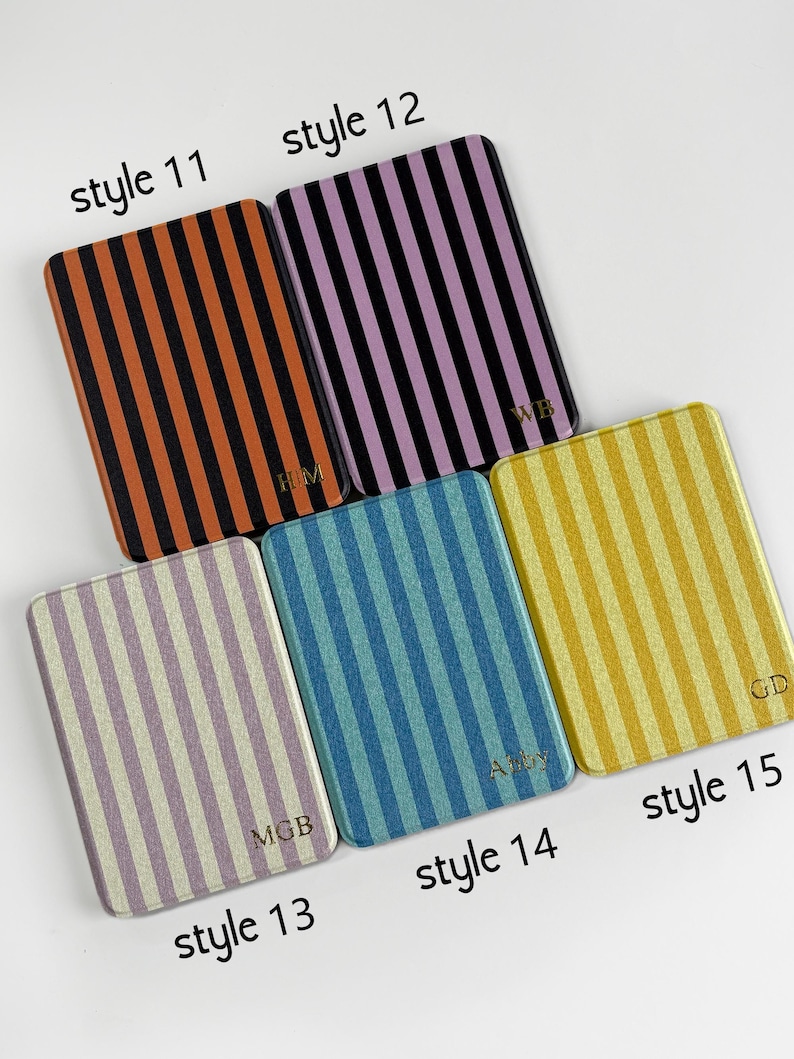 May include: Five rectangular coasters with vertical striped patterns in various colours: orange and black, purple and black, light purple and white, blue and light blue, and yellow and gold. Each coaster is labelled with a style number.