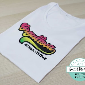 May include: A white t-shirt with a colorful graphic that says "Orgullosa" with the text "Hispanic Heritage" underneath. The graphic is in a rainbow color scheme with a yellow, green, and red gradient.