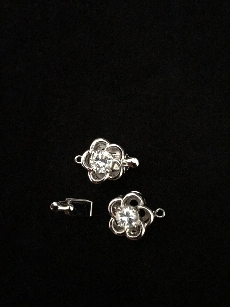 Two 12 mm Rhodium Plated and CZ Twisted Flower Tab Clasp