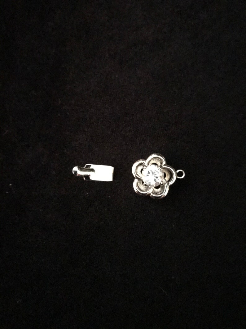 Two 12 mm Rhodium Plated and CZ Twisted Flower Tab Clasp