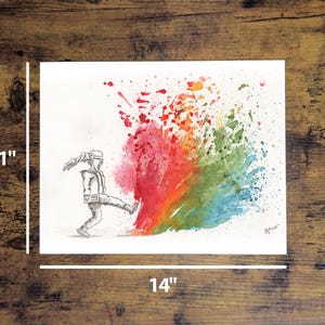 May include: An 11 x 14 inch watercolor print depicts a figure kicking a burst of colorful paint. The paint explosion transitions from red to orange, green, and blue. The figure is drawn in black and white, with a dynamic pose.