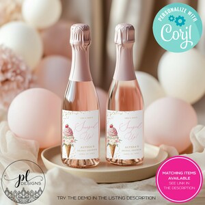 May include: Two mini champagne bottles with pink labels that read "Scooped Up!" with an ice cream cone graphic. The bottles are on a beige tray, surrounded by pink and white balloons. The text "Alyssa's Bridal Shower" is also on the label.