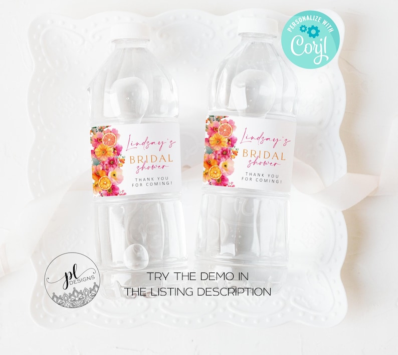 May include: Two clear plastic water bottles with labels featuring floral designs and the text "Lindsay's Bridal Shower." The labels include pink, orange, and yellow flowers. The bottles are on a white decorative tray. The text "Thank you for coming!" is also on the label.