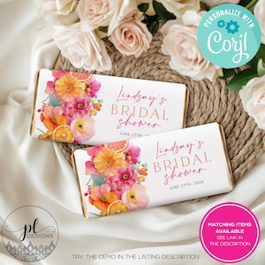 May include: Two white candy bar wrappers with floral designs and the text "Lindsay's Bridal Shower" in pink. The wrappers feature watercolor flowers in shades of pink, orange, and yellow, with orange slices. The date June 27th, 2026 is also printed.
