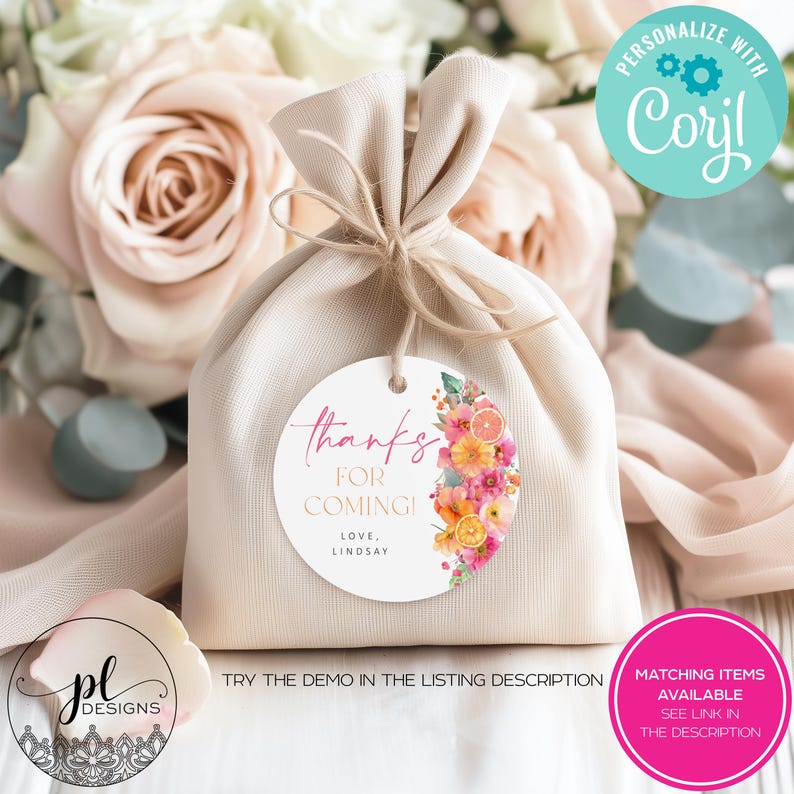 May include: A beige fabric gift bag tied with twine, featuring a round tag with floral and citrus designs. The tag reads "thanks for coming!" and "love, Lindsay". Additional text includes "Personalize with Corjl" and "Matching items available see link in the description."