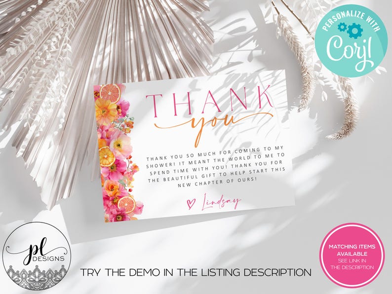 May include: A white card with the words "THANK YOU" in pink and orange script. The card is decorated with a floral design of pink and orange flowers and citrus slices. Text on the card reads "Thank you so much for coming to my shower!" and "Lindsay".