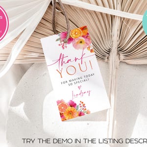May include: A white gift tag with the words "thank YOU!" in pink and orange script, accented with floral and citrus illustrations. The tag includes the text "FOR MAKING TODAY SO SPECIAL!" and a name. A brown string is attached.