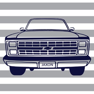 May include: Illustration of a navy blue and white pickup truck with the name "Jaxon" on the license plate. The truck is set against a background of horizontal gray and white stripes. The Chevrolet logo is visible.
