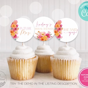 May include: Three cupcakes with white frosting, each topped with a white circle featuring floral designs and text. The text reads "FUTURE Mrs.", "Lindsay's BRIDAL SHOWER", and "SHE SAID yes!". The image includes the text "TRY THE DEMO IN THE LISTING DESCRIPTION".