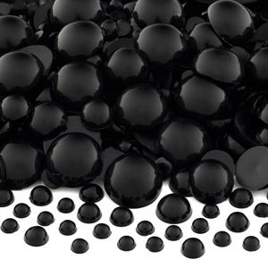 May include: A large pile of black plastic dome-shaped buttons of various sizes. The buttons are arranged in a random pattern and are all the same color.
