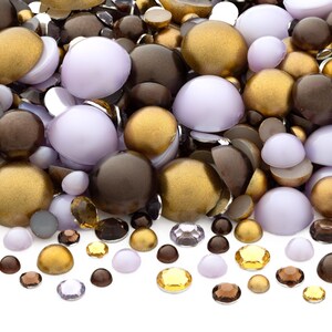 May include: Assortment of round, flat-backed cabochons in various sizes. The cabochons are in shades of brown, gold, and lavender.