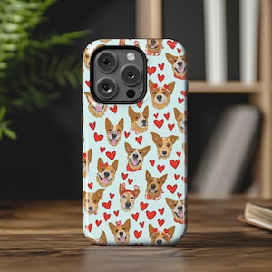 May include: A blue and white phone case with a pattern of red hearts and cartoon dogs wearing red bows. The case is designed for an iPhone.