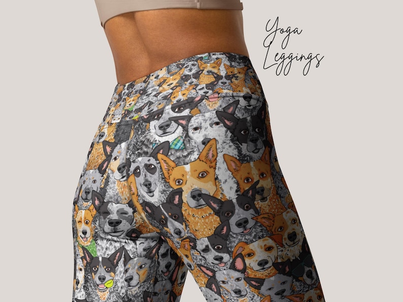May include: Yoga leggings with a colorful pattern of Australian Shepherd dogs. The leggings are black with a variety of dog breeds in different colors and poses.