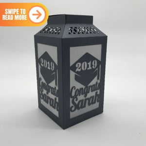 May include: Black paper lantern with a white interior. The lantern has a graduation cap design and the text "2019 Congrats Sarah".