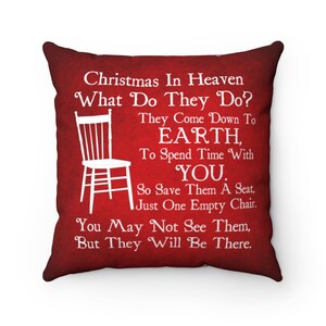 May include: Red throw pillow with white text that reads "Christmas In Heaven What Do They Do? They Come Down To EARTH, To Spend Time With YOU. So Save Them A Seat, Just One Empty Chair. You May Not See Them, But They Will Be There."