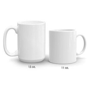 May include: Two white ceramic mugs, one is 15 oz and the other is 11 oz.