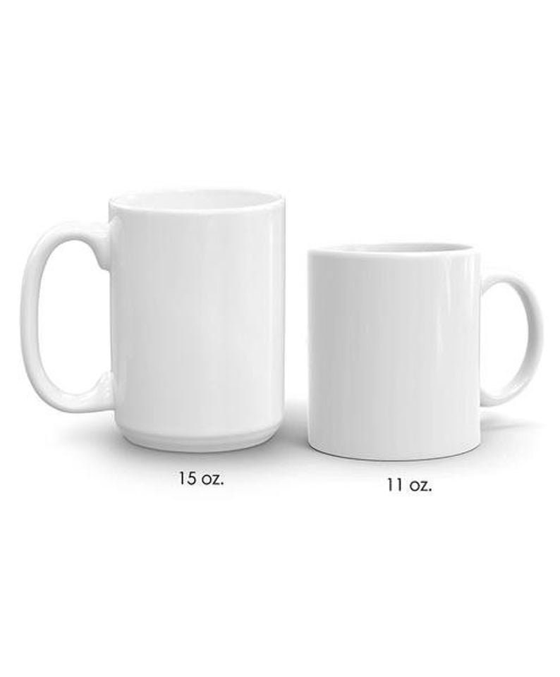 May include: Two white ceramic mugs, one is 15 oz and the other is 11 oz.