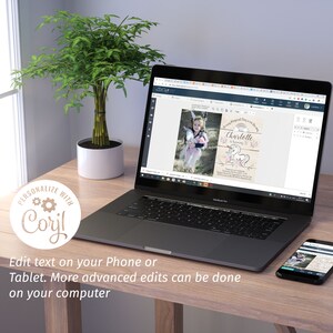 May include: A laptop displays a birthday invitation with a unicorn theme. The invitation features a photo of a child, a rainbow, and floral accents. The laptop is on a wooden desk, with a potted plant and a smartphone nearby. Text on the screen reads "Charlotte is turning 3!"
