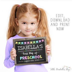 May include: A young girl with red hair holds a chalkboard sign. The sign has a wooden frame and reads "ISABELLA'S First Day of PRESCHOOL" with the date "August 25th, 20XX." Colorful banner flags decorate the top. The text "EDIT, DOWNLOAD AND PRINT NOW" is in the background.
