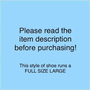 May include: Blue background with white text that reads "Please read the item description before purchasing! This style of shoe runs a FULL SIZE LARGE."