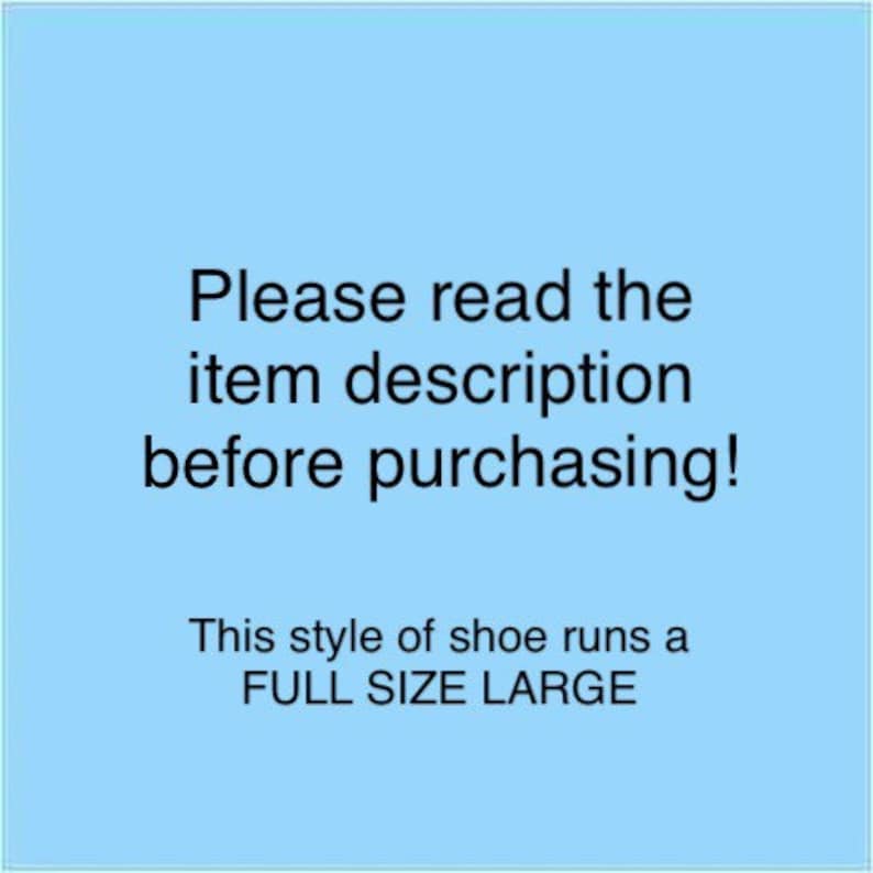 May include: Blue background with white text that reads "Please read the item description before purchasing! This style of shoe runs a FULL SIZE LARGE."
