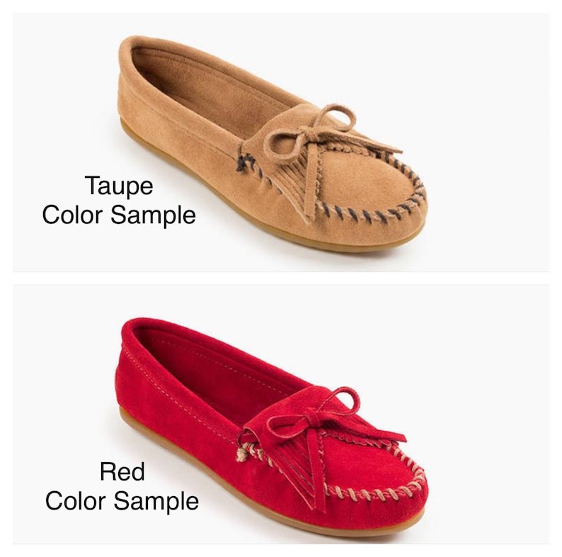 May include: Two pairs of moccasins, one in taupe and one in red. Both pairs have a fringe detail and a bow at the top.
