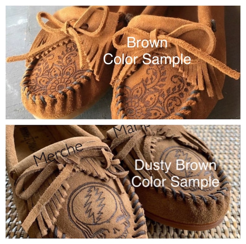 May include: Two pairs of brown suede moccasins with fringe. The moccasins on the top are labeled "Brown Color Sample" and the moccasins on the bottom are labeled "Dusty Brown Color Sample".