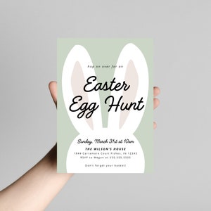 May include: A green invitation with bunny ears for an Easter egg hunt. The invitation includes the date, time, location, and RSVP information. It also says "Don't forget your basket!"