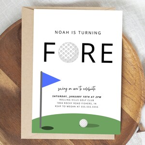 May include: A white card with black text that reads "Noah is turning FORE" with a golf ball graphic. The card is on a brown wooden surface with a blue and green golf course graphic at the bottom. The text below the graphic reads "swing on over to celebrate Saturday, January 10th at 2PM Rolling Hills Golf Club 1804 Rocky Road Fishers, IN RSVP to Megan at 555.555.5555"