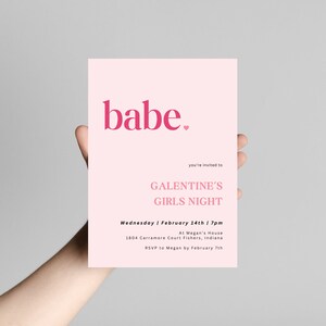 May include: Pink invitation card with the text "babe." in bold pink letters with a small pink heart. The text "you're invited to GALENTINE'S GIRLS NIGHT" is in black text. The details of the event are listed below: "Wednesday | February 14th | 7pm At Megan's House 1804 Carramore Court Fishers, Indiana RSVP to Megan by February 7th"
