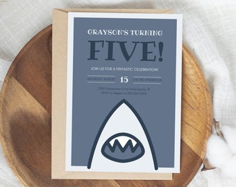 May include: A blue and white birthday party invitation featuring a shark graphic. The invitation reads "Grayson's Turning Five!" and includes the date, time, and location of the party.