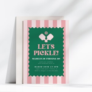 May include: A pink and white striped invitation card with the text "LET'S PICKLE!" in green. The invitation is for Madelyn's 30th birthday and includes event details. The card features a pickleball theme with paddles and a ball.