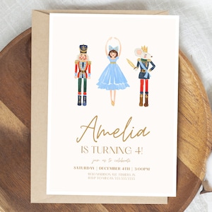 May include: A white invitation card with a gold border and text. The card features illustrations of a Nutcracker, a ballerina, and a mouse king. The text reads "Amelia is turning 4!" and includes details for a birthday party.