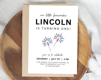 May include: A white card with red, white, and blue fireworks on it. The text on the card reads "our little firecracker LINCOLN IS TURNING ONE!" and "join us to celebrate SATURDAY | JULY 1ST | 2 PM 1776 FOREST HILLS DRIVE FISHERS, IN RSVP TO MEGAN BY JULY 1ST AT 555.555.5555".