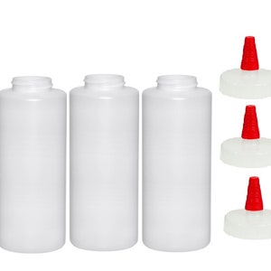 May include: Three white plastic squeeze bottles with red flip-top lids. The bottles are empty and ready to be filled with condiments or sauces.