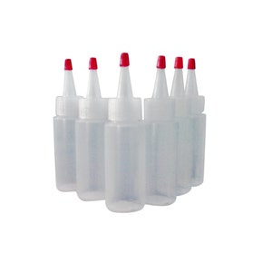 May include: Six clear plastic bottles with red squeeze tops. The bottles are arranged in a semi-circle.