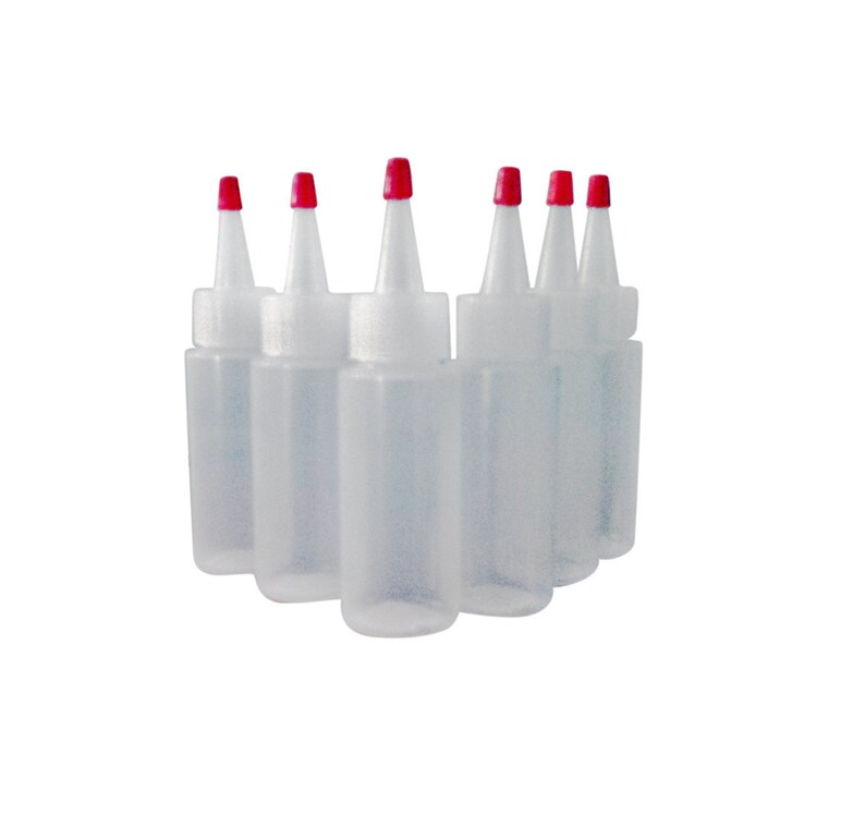 May include: Six clear plastic bottles with red squeeze tops. The bottles are arranged in a semi-circle.