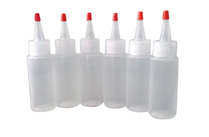 May include: Six clear plastic squeeze bottles with red caps. The bottles are empty and have a narrow opening.