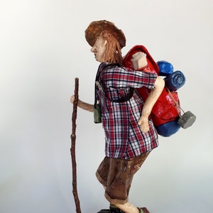 The Hiker with a Back-pain-paper mache sculpture