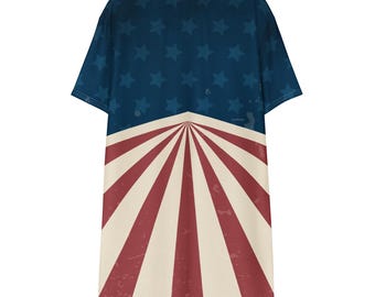 May include: A short-sleeved t-shirt dress with a patriotic design. The top section has a navy blue background with white stars. The bottom half features a red and white striped pattern, similar to the American flag.